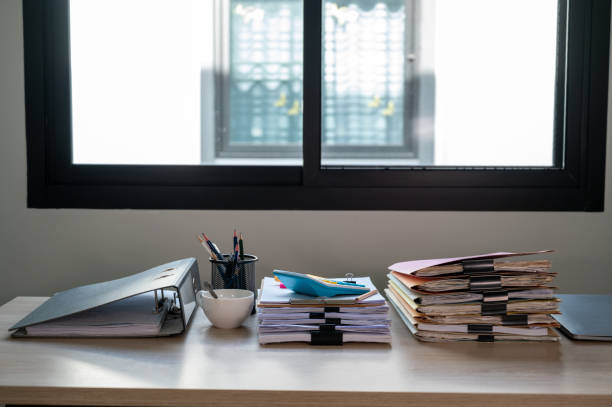 istock Stack of documents with paper clip folder placed on a business desk in a business office. 1341817982