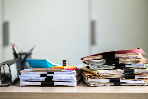 istock Stack of documents with paper clip folder placed on a business desk in a business office. 1341817985