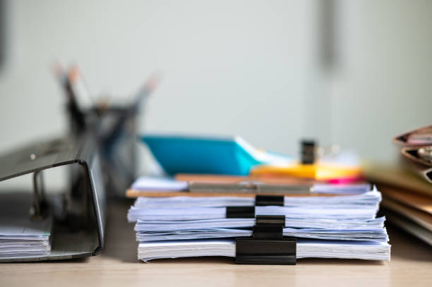 istock Stack of documents with paper clip folder placed on a business desk in a business office. 1341817987