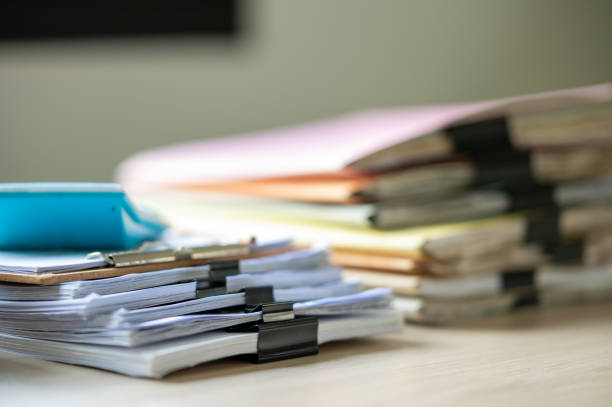 istock Stack of documents with paper clip folder placed on a business desk in a business office. 1341817988