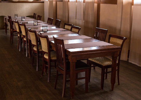 Long brown table with chairs