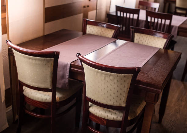 istock Dining table in brown wood with elegant chairs 1341819085