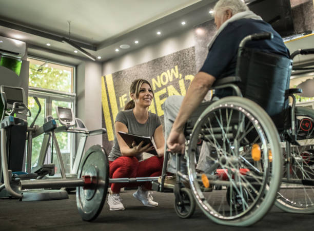 istock disabled senior man on wheelchair doing exercise 1341819207