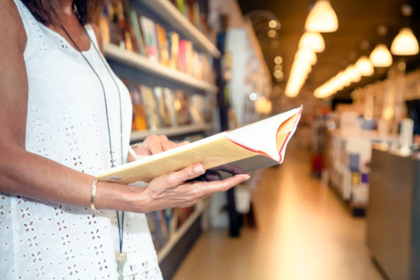 istock Woman reading in the bookstore 1341819394