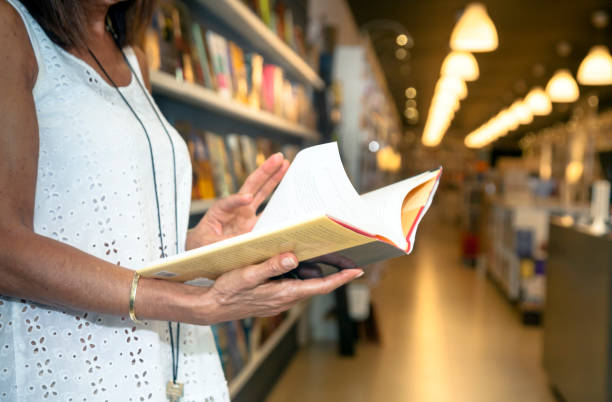istock Woman reading in the bookstore 1341819396