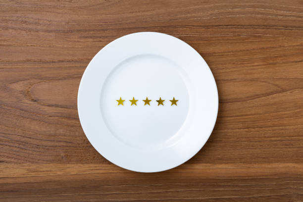 istock Five stars on white plate on wooden background 1341821779
