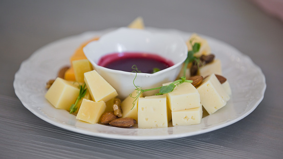 various types of cheese with sauce, Pieces of cheese and sauce on a plate in a restaurant.