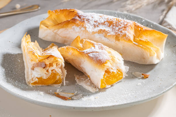 istock Typical portuguese sweets Pasteis de Vouzela served on countertop. Filo pastry with egg cream filling 1341823613
