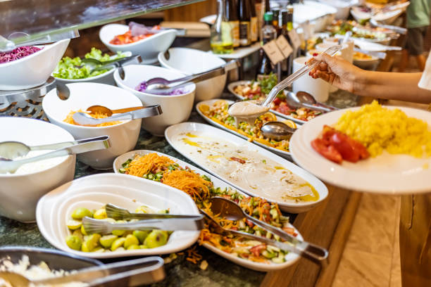 istock Woman taking food from a buffet line 1341823642