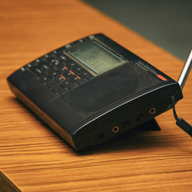 istock Black analog radio receiver on wooden table 1341823705
