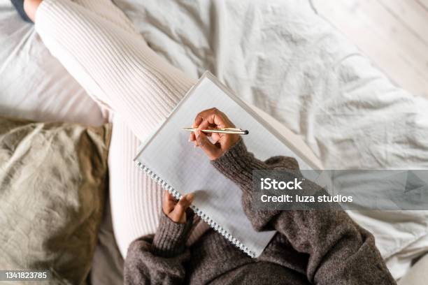 Woman Writing In Bed Stock Photo - Download Image Now - Diary, Writing - Activity, Note Pad