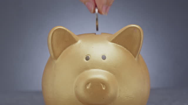 Saving money with a golden piggy bank.