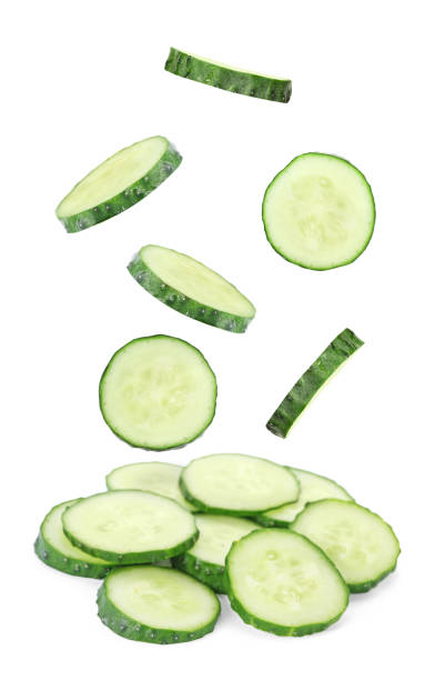 istock Set of flying fresh cucumber slices on white background 1341826501