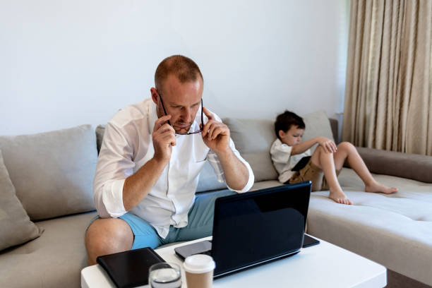 istock Smiling dad working at home with his boy. 1341826741