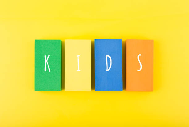 istock Word kids on colorful rectangles against bright yellow background 1341827839