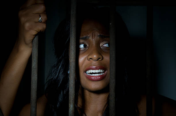 istock Young Woman Behind Bars 134182833