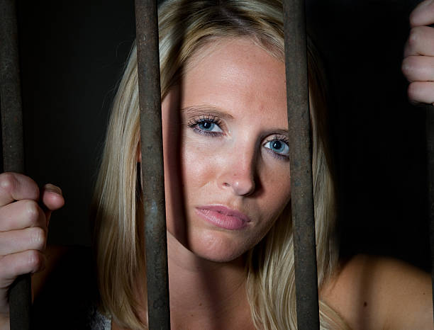 istock Young Woman Behind Bars 134182887