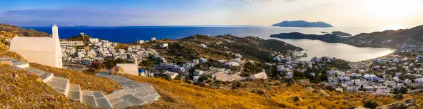 Photo of Breathtaking panoramic sunset view of Ios island. Chora town with churches and whitwashed houses. Popular tourist destination in Cyclades, Greece