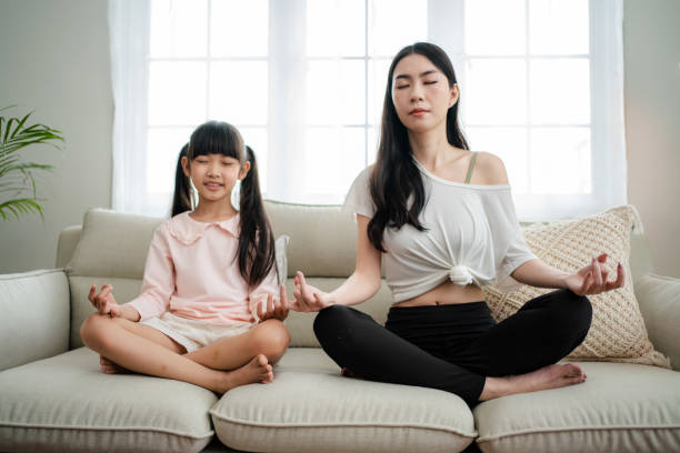 istock Young mother and daughter making a exercises at home. 1341829244