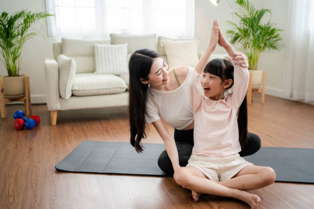 istock Young mother and daughter making a exercises at home. 1341829257