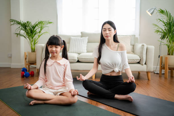 istock Young mother and daughter making a exercises at home. 1341829271