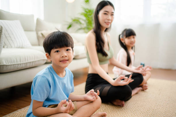 istock Young mother and child making a exercises at home. 1341829283