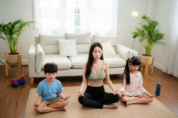 istock Young mother and child making a exercises at home. 1341829316