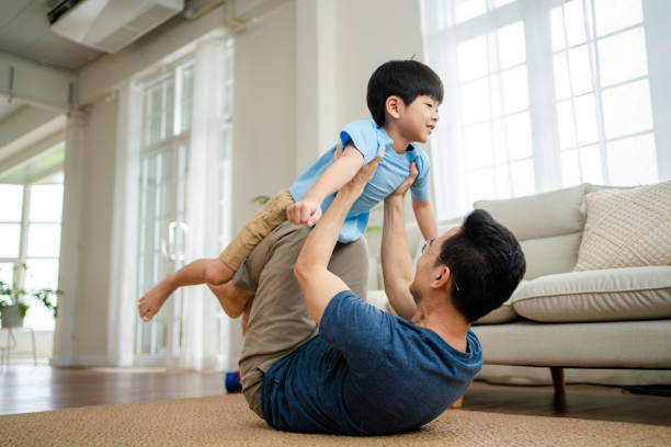istock Joyful  father lifting excited happy son. 1341829369