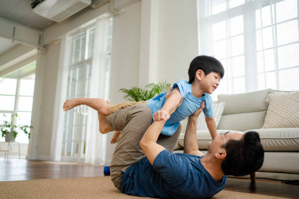 istock Joyful  father lifting excited happy son. 1341829370