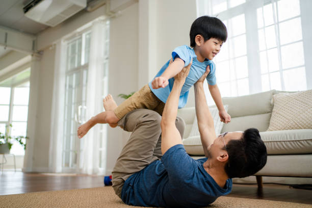 Joyful  father lifting excited happy son.