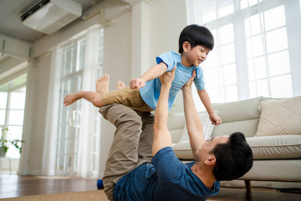 istock Joyful  father lifting excited happy son. 1341829373