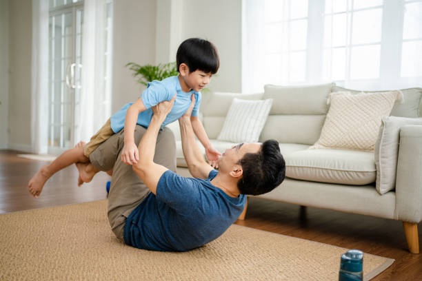 istock Joyful  father lifting excited happy son. 1341829383