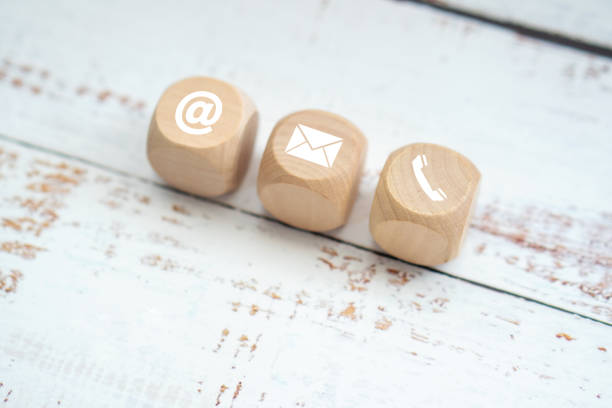 istock contact us icon (phone, email, mail ) on wood cube, customer service and support for self quarantine business working at home for Coronavirus or virus preventing concept 1341830281