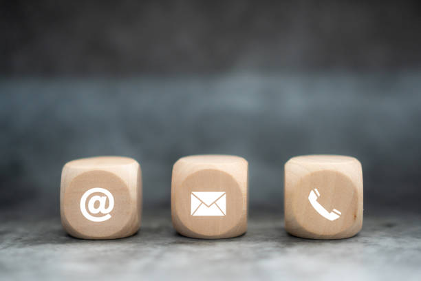 istock contact us icon (phone, email, mail ) on wood cube, customer service and support for self quarantine business working 1341830356