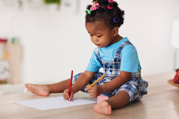 cute toddler baby girl drawing with pencils using both hands cute toddler baby girl drawing with pencils using both hands right handed stock pictures, royalty-free photos & images