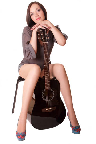 istock Young adult female is playing guitar 1341832568