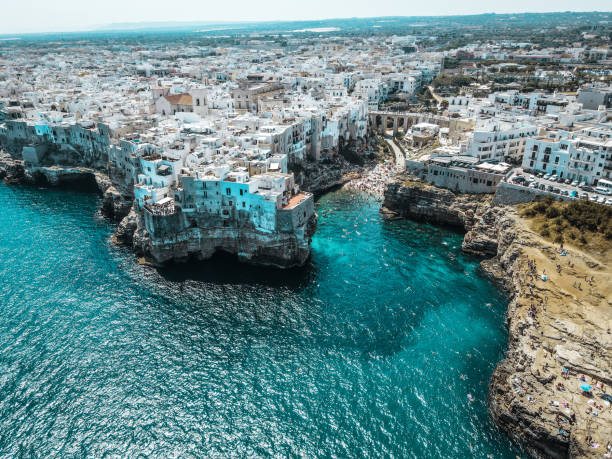 Aerial view Polignano a Mare, Puglia Aerial view of Polignano a Mare, in Puglia, south Italy. Drone view from above of this beautiful town on the cliffs in apulia. ostuni beach stock pictures, royalty-free photos & images