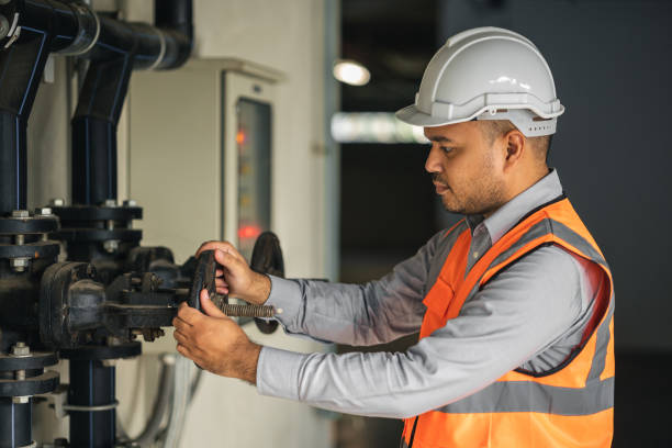 istock Young asian engineer working at valve water pump checking and maintenance for the safety. Worker control the system water of the building. 1341833614
