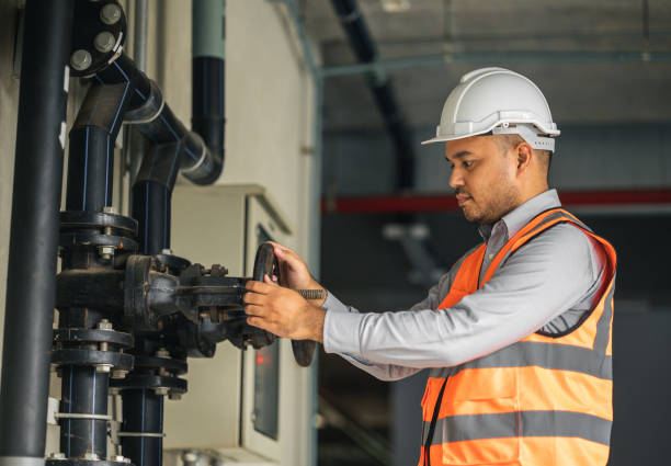 istock Young asian engineer working at valve water pump checking and maintenance for the safety. Worker control the system water of the building. 1341833631