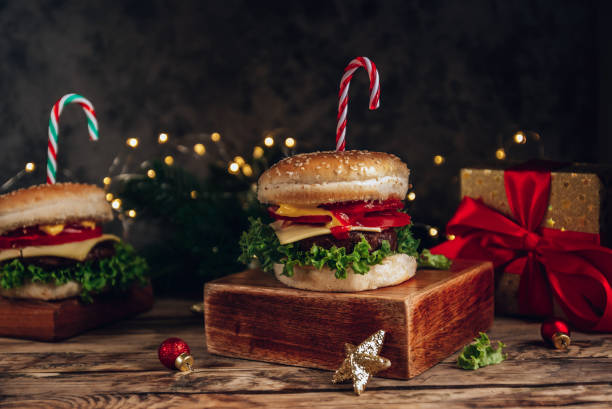 istock Christmas burger concept, with cande cane and christmas lights bokeh. Dark background, Selective focus 1341836062