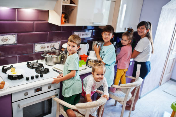 istock Happy children's at kitchen 1341838801