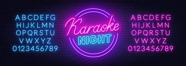 Karaoke night neon sign on brick wall background. Karaoke night neon sign on brick wall background. Neon blue and pink alphabet. karaoke stock illustrations