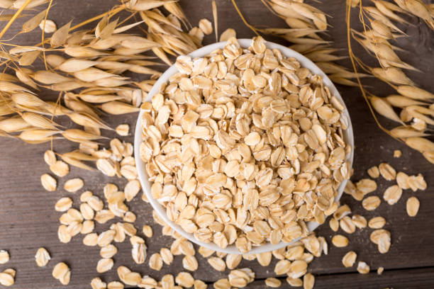 istock oat flakes on bowl, wodden background 1341840136