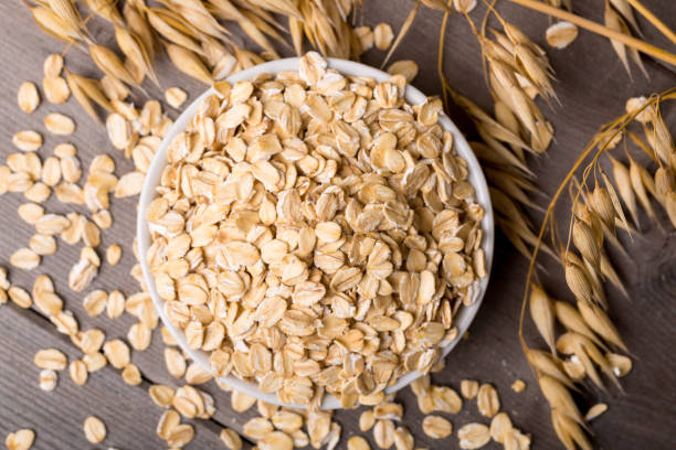 istock oat flakes on bowl, wodden background 1341840161