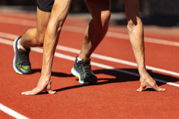 istock One young sportive man, male athlete, runner practicing alone before race at public stadium, sport court or running track, outdoors. Professional sport games. 1341840175