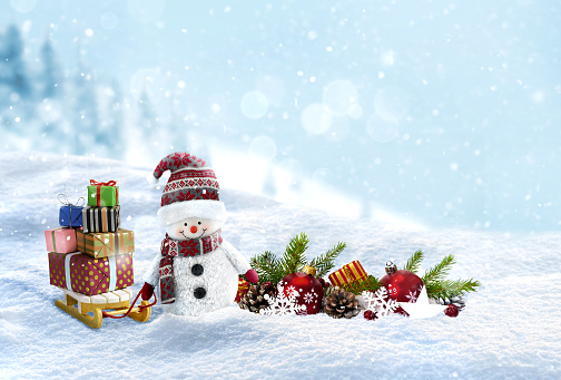 Cute Snowman with christmas presents on the sleigh on snowy landscape background . New year and christmas Holidays card.