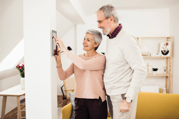 istock Happy senior man and woman using a smart system at their house 1341844859