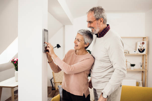 istock Happy senior couple using a smart system at their house 1341844865