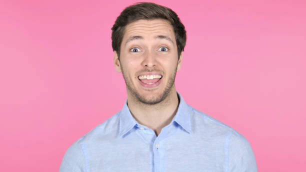 istock Online Video Chat by Young Man on Pink Background 1341845793