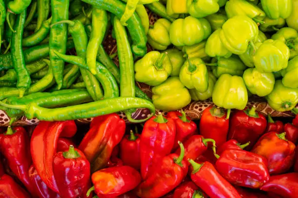 Mix of chili peppers, bell peppers, capi color assortment on vegetable market